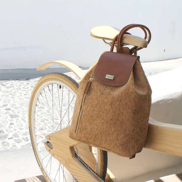 An eco-friendly cork backpack from SunBeam on a wooden bike in Megalochori, a traditional village on the island of Santorini.