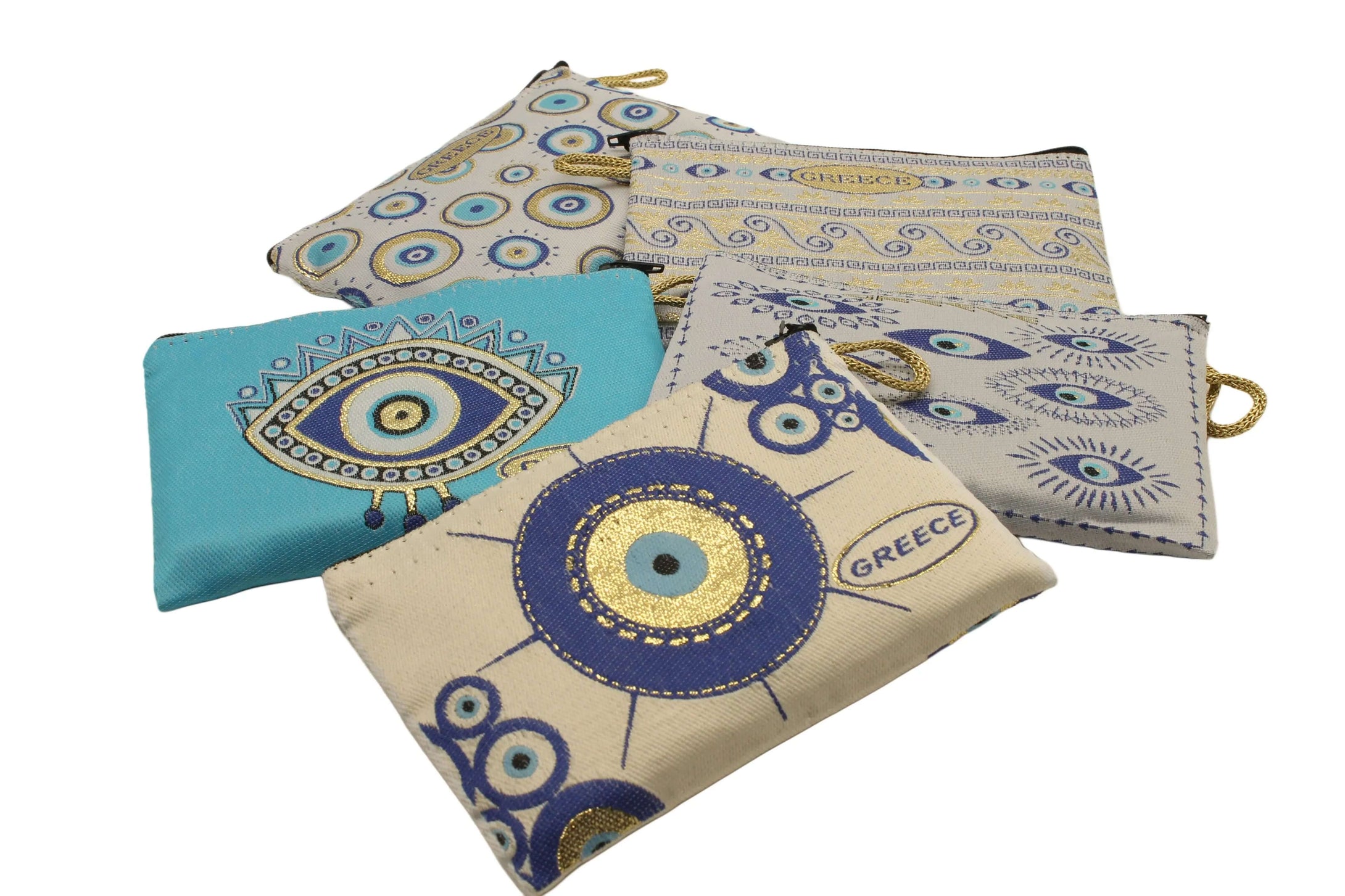 Collection of colorful patterned purse wallets featuring traditional Greek eye motifs on a white background.